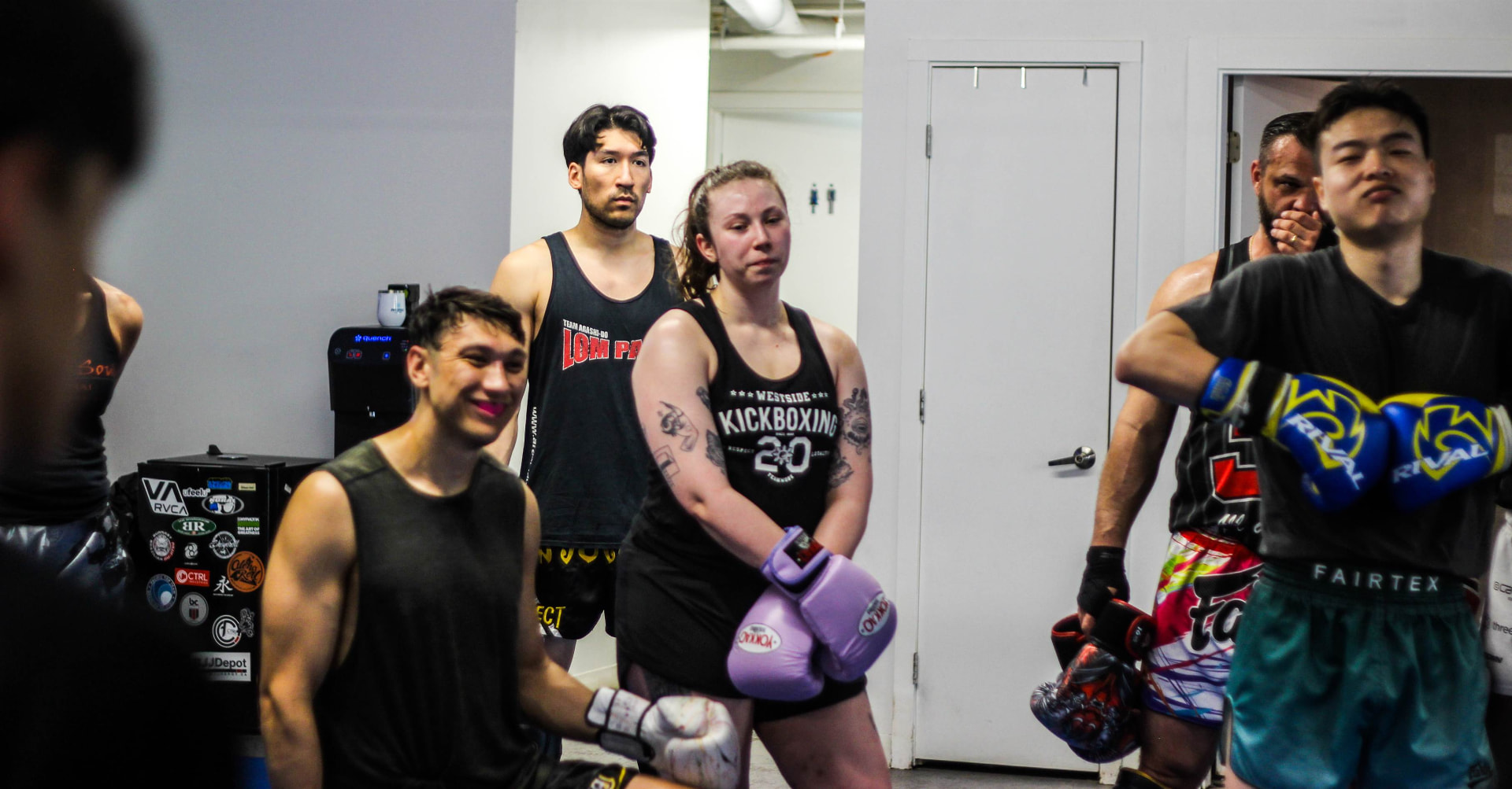 Students gloved up and listening during a Muay Thai class