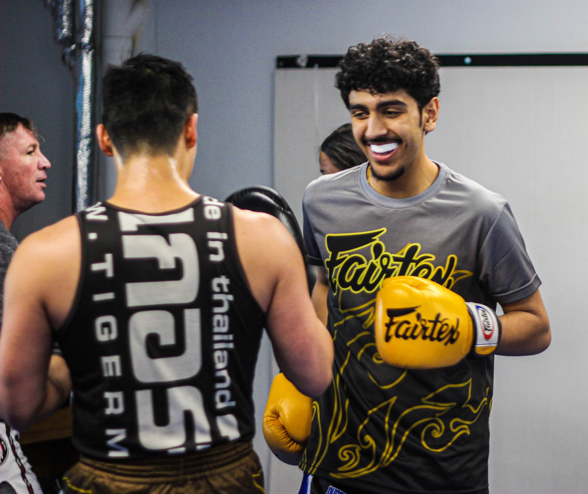 Two training partners smiling before a pad round